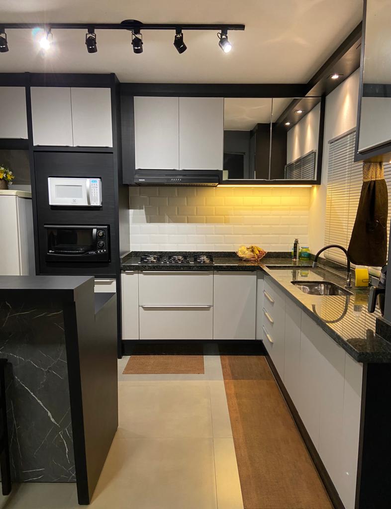 Cozinha executada com marcenaria off-white e bancada em granito verde